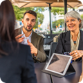meeting of multiple people discussing over tablet